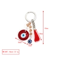 Macro view of evil eye keychain with red tassel, champagne beads and silver metal ring - Red Disc Charm Tassel