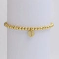 Detail of a gold beaded bracelet featuring a round pendant with engraved letter J - Letter J (DB240603-J)