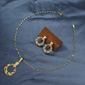 Macro detail of golden geometric spiral necklace and earring set on dark fabric - E6107-17/Gold Hollow Spiral Ring