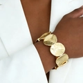 Statement gold hammered geometric metal disc stretch bracelet worn by a female model - Oval Hammered Texture Metal Bracelet (A-1112) / Gold