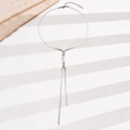 Detailed view of polished silver snake chain necklace in a Y-shaped tie knot design - Silver