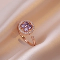 Close-up of rose gold spinning ring with purple heart-shaped stones in clover design - Ring / Rose Gold - Purple