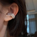 Elegant silver zircon flower ear cuff for non-pierced ears shown on a model ear - Ear Bone Clip (Single) / Silver