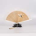 Classic folding fan with flying crane pattern and elegant tassel on wood stand - Narrow Edge Crane Natural Wood