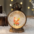 Christmas lantern with Santa Claus figurine and sparkling snow in antique bronze finish - Sitting Santa Claus