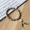 Thuja sutchuenensis wood waterdrop beads bracelet with a delicate white flower charm - 8x12mm*15 Beads + Plum Blossom Accessory / Green Sandalwood / Greenish Brown