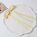 Pale yellow satin ribbon bow hair clip displayed on a white ceramic flower plate - Ribbon Duckbill Clip / Yellow