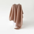Pleated light brown faux linen silk scarf draped over a minimalist white geometric stand - Almond