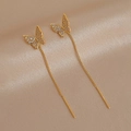 Detail of gold butterfly drop earrings with zircon pavé on champagne silk fabric - Gold Butterfly Earrings