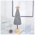 Close-up of handmade grey felt Christmas tree with gold star on a wooden base - Elegant Grey