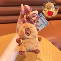 Close-up of plush capybara keychain with red ping-pong racket backpack and bell - Capybara with Table Tennis