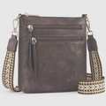 Close-up of brown pebbled leather crossbody bag with multi-zipper and woven strap - Coffee