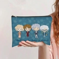 Detail of navy blue canvas makeup bag with cartoon figures and text held by a hand - The Golden Girls IP Style(jiayingpbb0398)