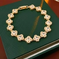 18k gold plated four-leaf clover bracelet with zircon crystals on a green jewelry box - Four-leaf Clover / Gold
