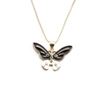 Close-up of gold butterfly pendant with black and white enamel and colorful crystals - Black