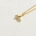 Gold butterfly necklace featuring zircon pavé wings and a delicate cross chain link - Heart Butterfly Zirconia 14K Gold