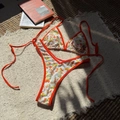 Two-piece floral bikini set in orange and white with side-tie bottoms and halter top - Orange Red