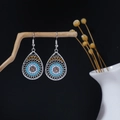 Detail of ethnic silver teardrop earrings with blue floral patterns and amber zircon - Hollow Tear-drop Amber Zirconia Style (E6342)