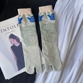 Light grey-green Tabi socks with blue bird pattern and pink trim flat lay on magazine - 35-41 / Pale Green Peace Dove