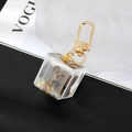 Detailed macro view of a brown teddy bear encased in a clear acrylic cube with gold sequins - Brown Bear