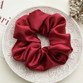 Deep red silk scrunchie with glossy satin texture on elegant ceramic tray - Large Wine Red