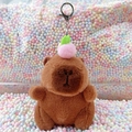 Plush brown capybara keychain with a pink peach accessory and silver metal clasp - Dark Brown Peach + Silver Clip