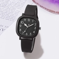 Detailed close-up of a square black minimalist watch dial with white Arabic numerals - Black