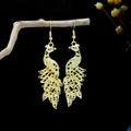 Detail of golden peacock earrings featuring hollow carving on natural wood branches - Gold Hollow Phoenix Ear Hook