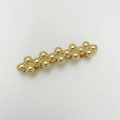 Detail of a golden beaded metal hair clip with a polished finish and spring clip base - Beaded Dot Gold