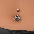 Silver punk belly ring with black gemstone spider pendant on a model's navel - Spider Style (3380)