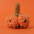 Handmade crochet pumpkin keychain in orange yarn with pumpkin face details - Orange Smiley Pumpkin