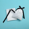 White microfiber drawstring jewelry pouches with black ribbons on a blue background - Double-side Ribbed Tape Slub Cotton / 12*16cm