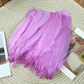 Detailed view of natural purple goose feathers on a woven mat for DIY crafts and decor - Stiff Light Purple (50Pcs)