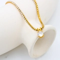 Close-up of gold-plated tennis chain necklace with a round clear zircon solitaire pendant - Zircon Tennis Chain / April-Clear Zircon