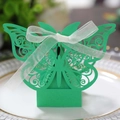 Detail of green laser-cut butterfly candy box with lace pattern and white ribbon bow - Dark Green