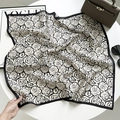 Classic black and white rose pattern square silk scarf displayed with fashion accessories - French Camellia