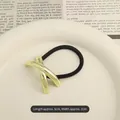Metallic gold cross-shaped hair tie with black high-elastic band and polished finish - X-Shape Polished Gold