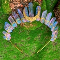 Detailed close-up of rainbow crystal crown with golden moon crest on green moss base - Pink Blue Crystal Hollow Moon