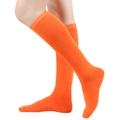 Detail view of bright orange knee-high socks with fine knitted texture on white background - One Size / Orange