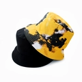 Detail of reversible tie-dye and plain black canvas bucket hats for sun protection - Adult 55-58cm / Yellow Tie-Dye
