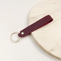 Minimalist burgundy leather keychain with a golden rivet and circular metal ring strap - No.3 Reddish Brown