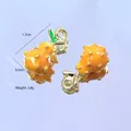 Detail view of yellow fruit charms with 1.7cm height, green leaves, and gold plating - Yellow Dragon Fruit
