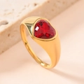 Macro shot of titanium steel ring featuring a red heart-shaped gemstone on a textured stone - US 6 / Red