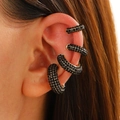 Close-up of four black rhinestone C-shaped ear cuffs set in gold on a model ear - Four-Piece Set / Black