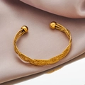 Elegant gold twisted wire cuff bracelet with polished bead ends on silk fabric background - 1143-Twisted Rope Multi-strand Bead Cuff