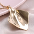 Detailed close-up of 18k gold plated geometric pendant with irregular crinkle texture - Gold Necklace