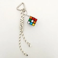 Detail of colorful mini Rubik's cube keychain with braided black and white nylon cord - Off-white Rope + Magic Cube