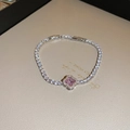 Macro view of a zircon tennis bracelet featuring a pink four-leaf clover centerpiece detail - 72# Bracelet - Pink - Four-leaf Clover