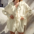 Chic beige two-piece set featuring a ruffled long sleeve blouse and matching casual shorts - S / Beige