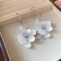 Detailed macro of white floral resin earrings with pearl and rhinestone center accents - White 3D Flower Pearl Rhinestone (16# Silver Pin)